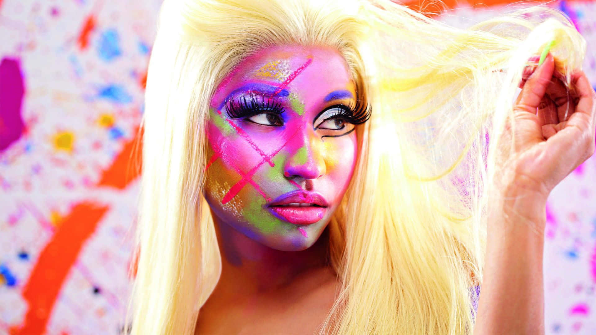 Nicki Minaj striking a pose against a blue backdrop