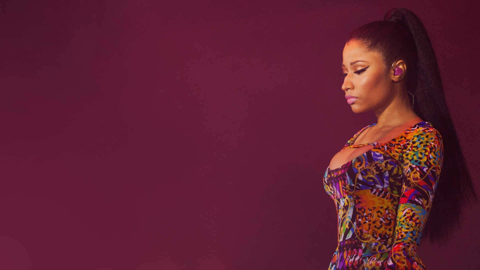 Nicki Minaj strikes a bold pose in a vibrant outfit