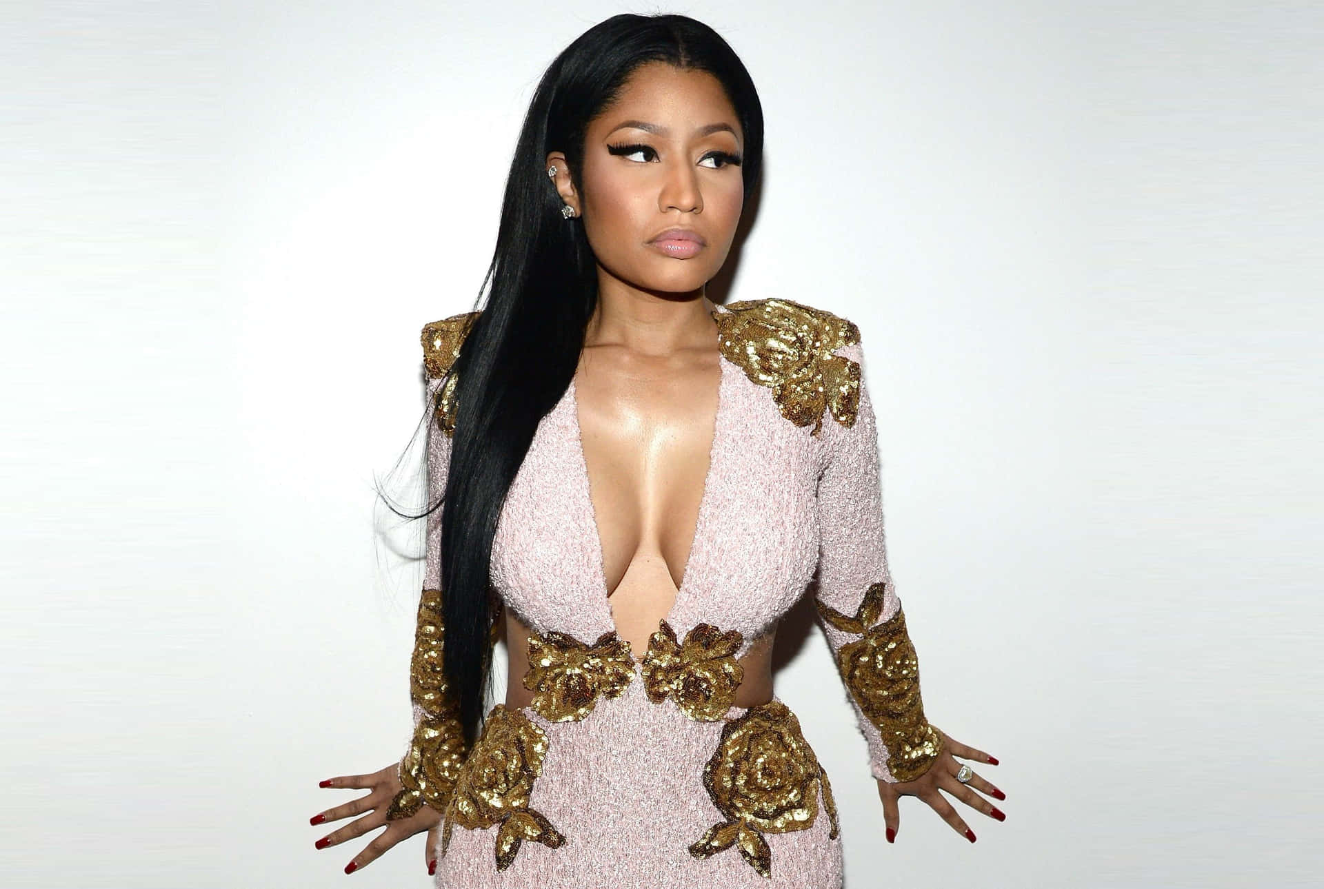 Nicki Minaj posing elegantly in a colorful outfit