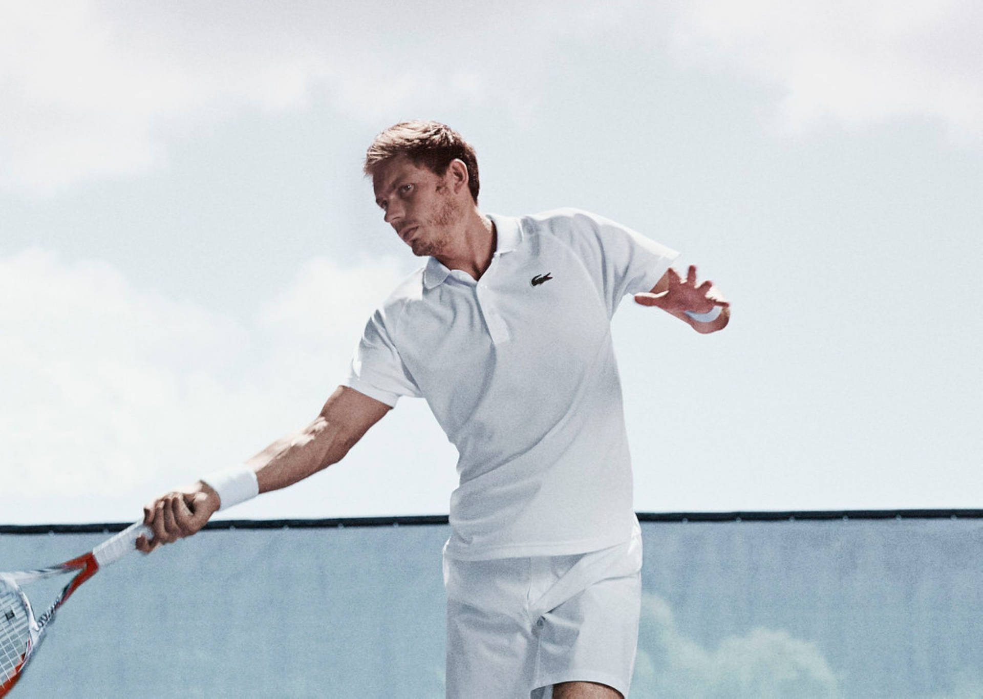 Nicolas Mahut donned in Lacoste sportswear, displaying a perfect pose with his tennis racquet. Wallpaper