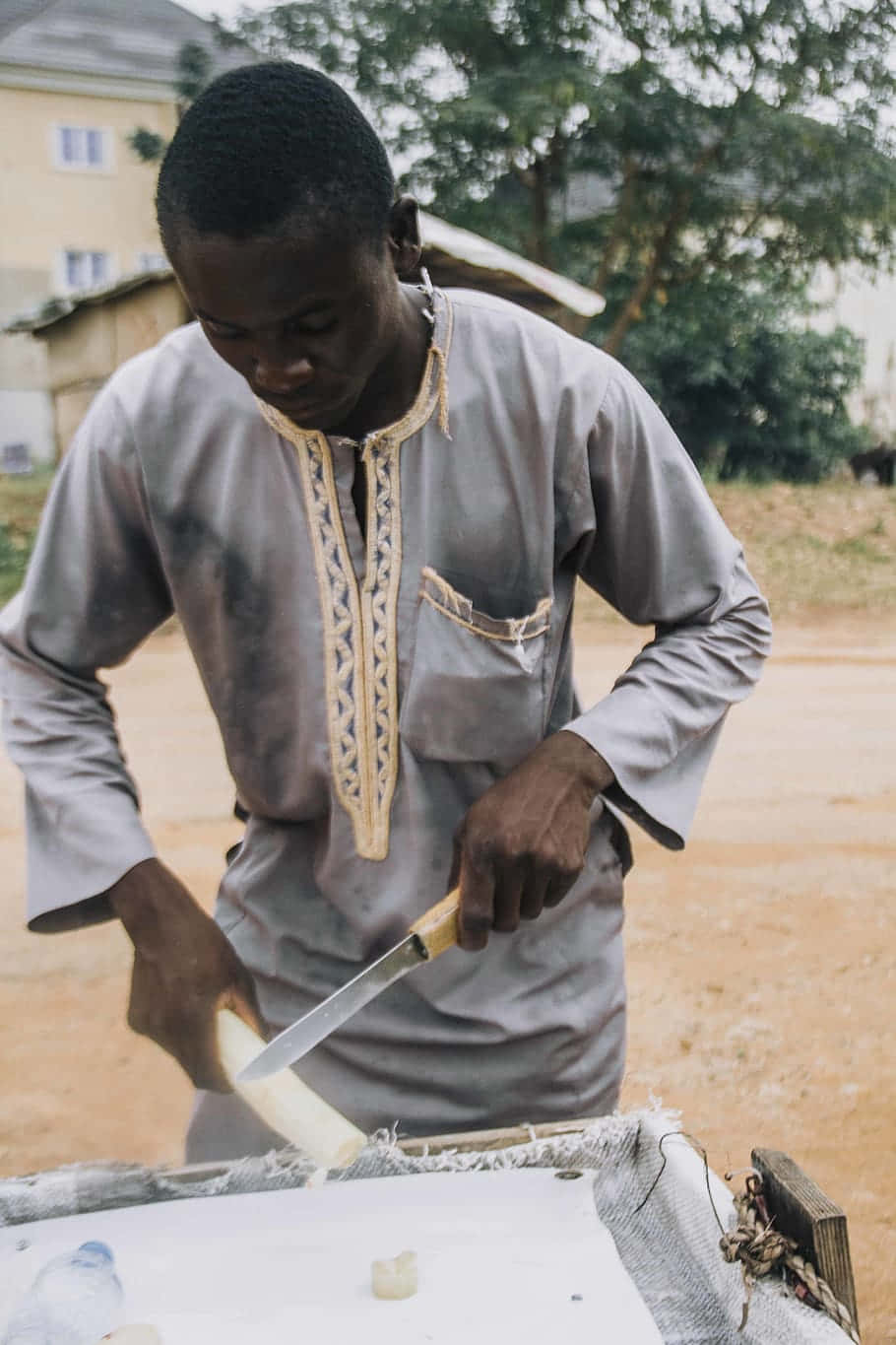 Nigerian Man Skillfully Harvesting Sugarcane Wallpaper