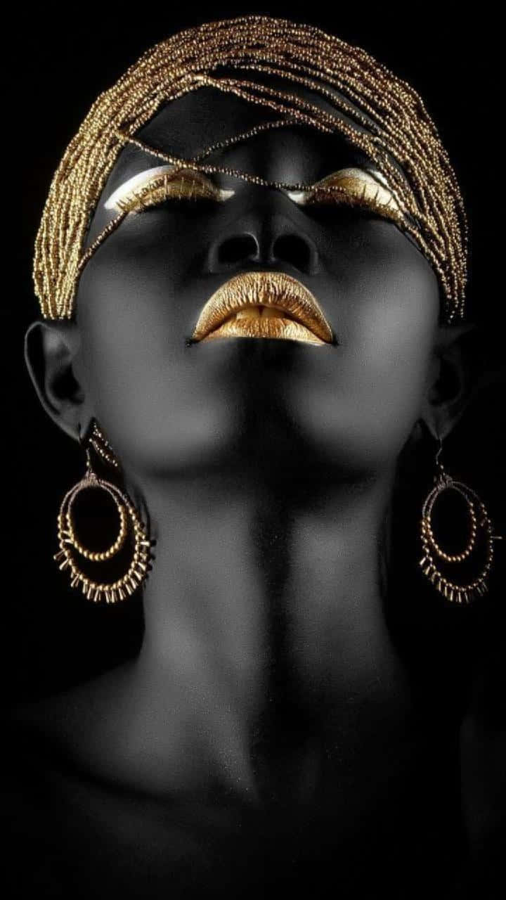 Empowered Nigerian Woman in Traditional Gold Gele Wallpaper