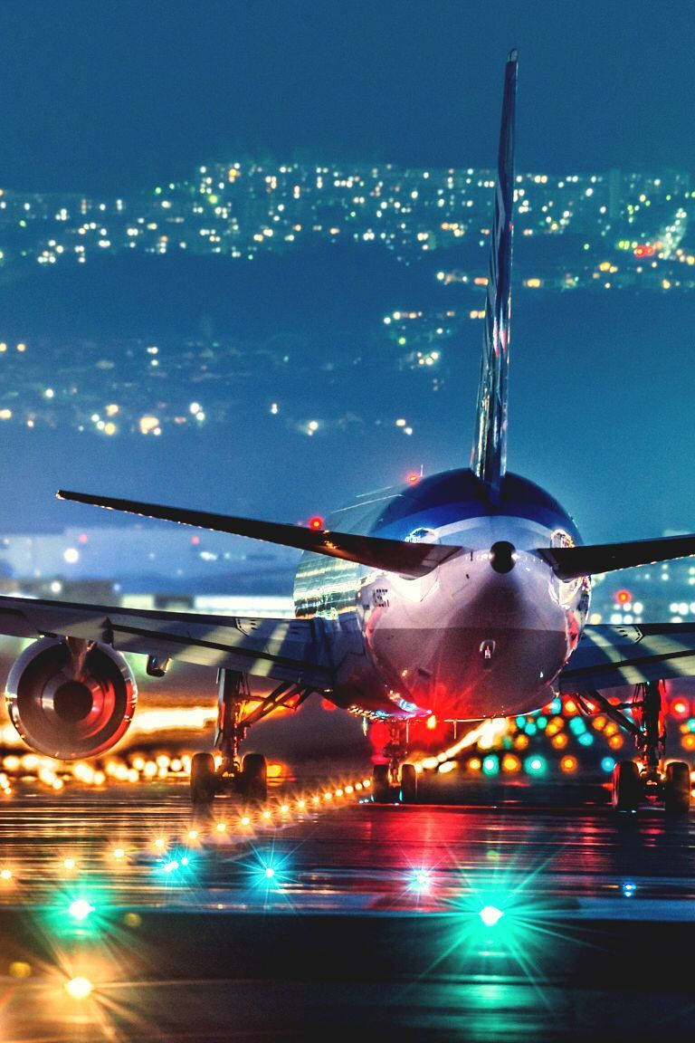 Download Night At The Runway With Jet Iphone Wallpaper 