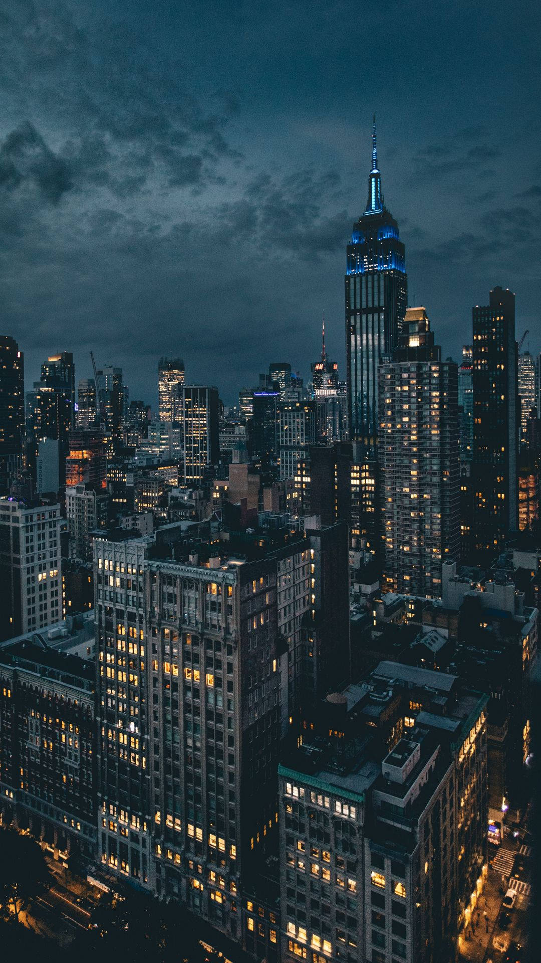 A Cityscape At Night With Buildings And Lights Wallpaper