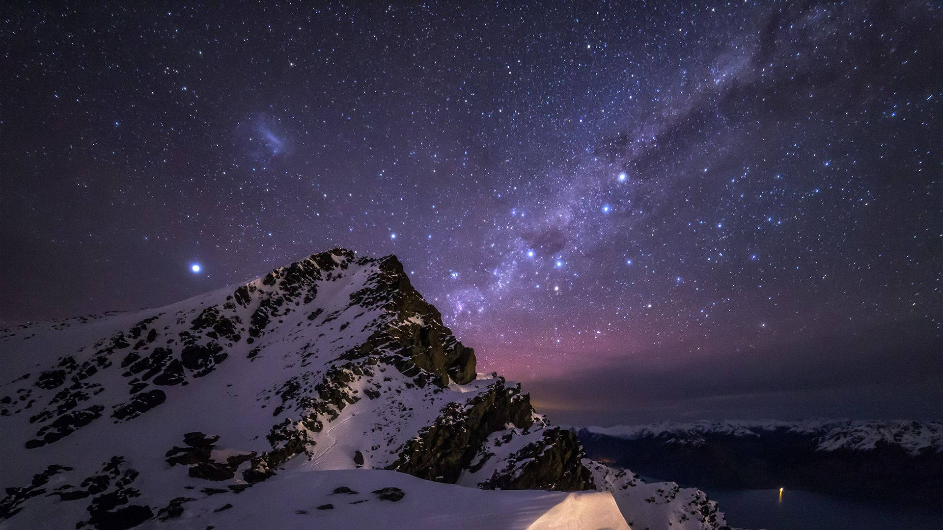 A Mountain With Snow And Stars Above It Wallpaper