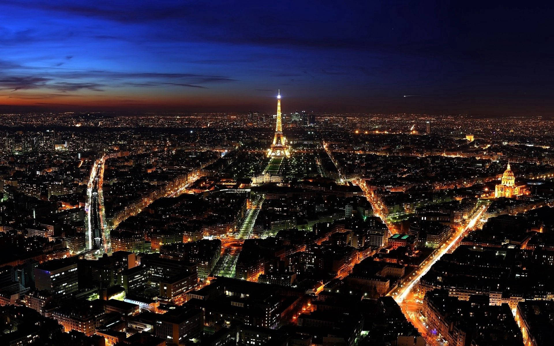 “A Nighttime View Of The City Of Lights” Wallpaper