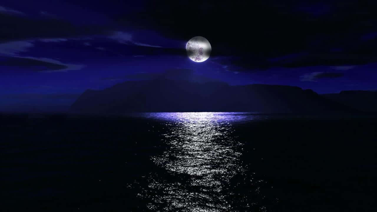 A Moon Is Seen Over The Water And Mountains