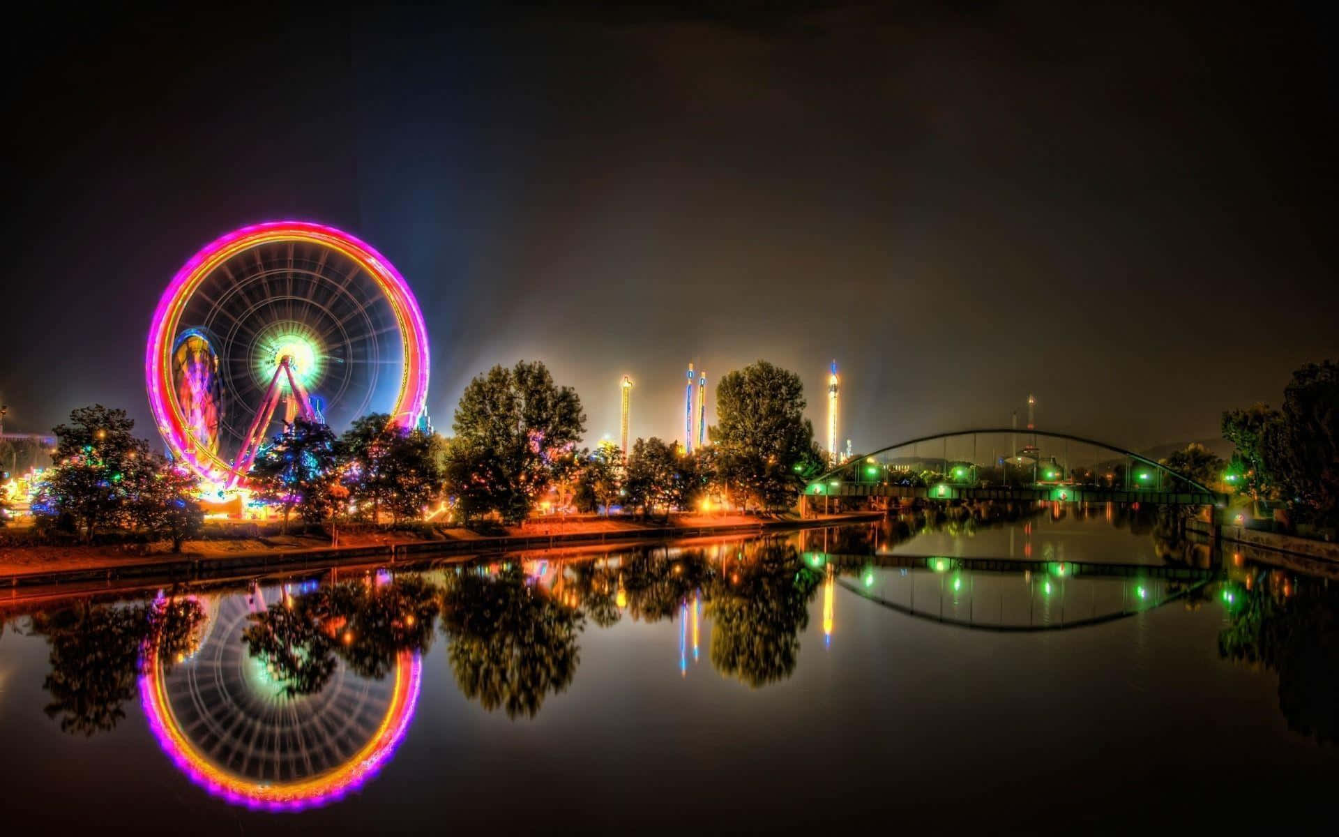 Nighttime Ferris Wheeland Bridge Reflection Wallpaper