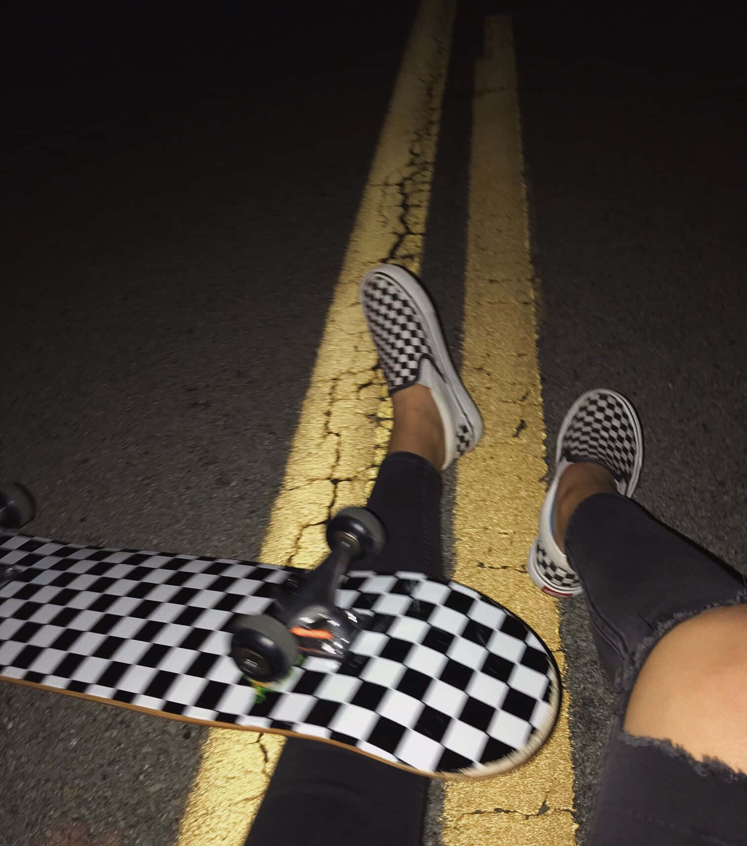 Nighttime Skateboarder Checkered Shoesand Board Wallpaper