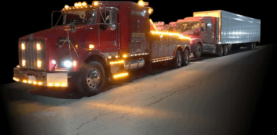Nighttime Tow Truck Hauling Semi Trailer PNG