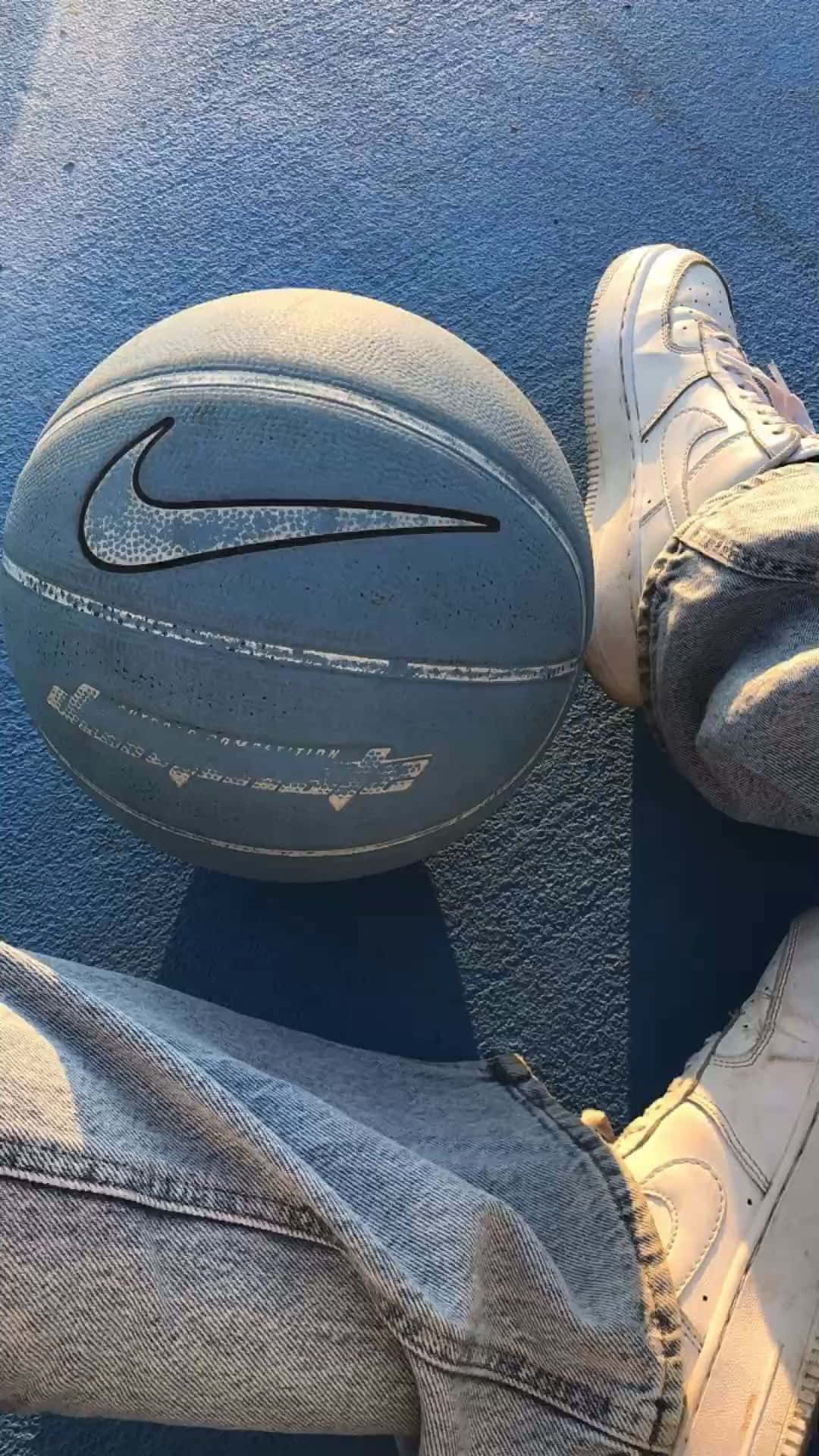 A Person Wearing Jeans And A Nike Ball Wallpaper