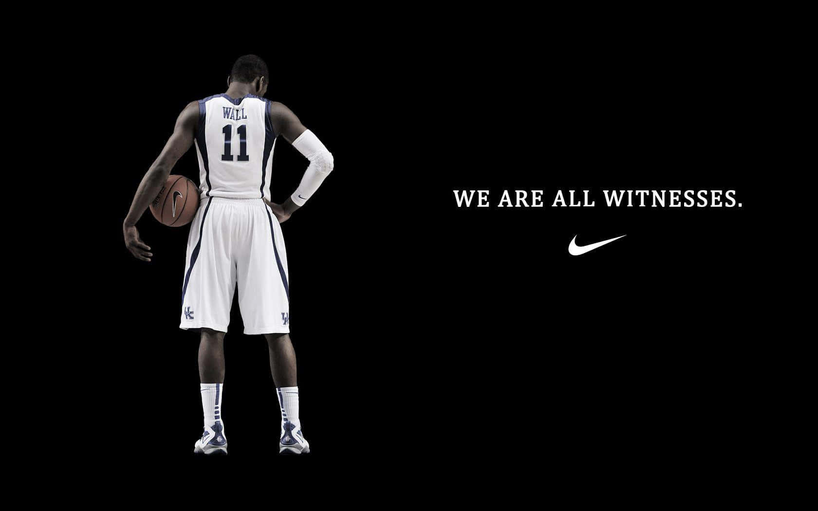 En basketballspiller med ordene Vi er alle vidner som baggrund Wallpaper