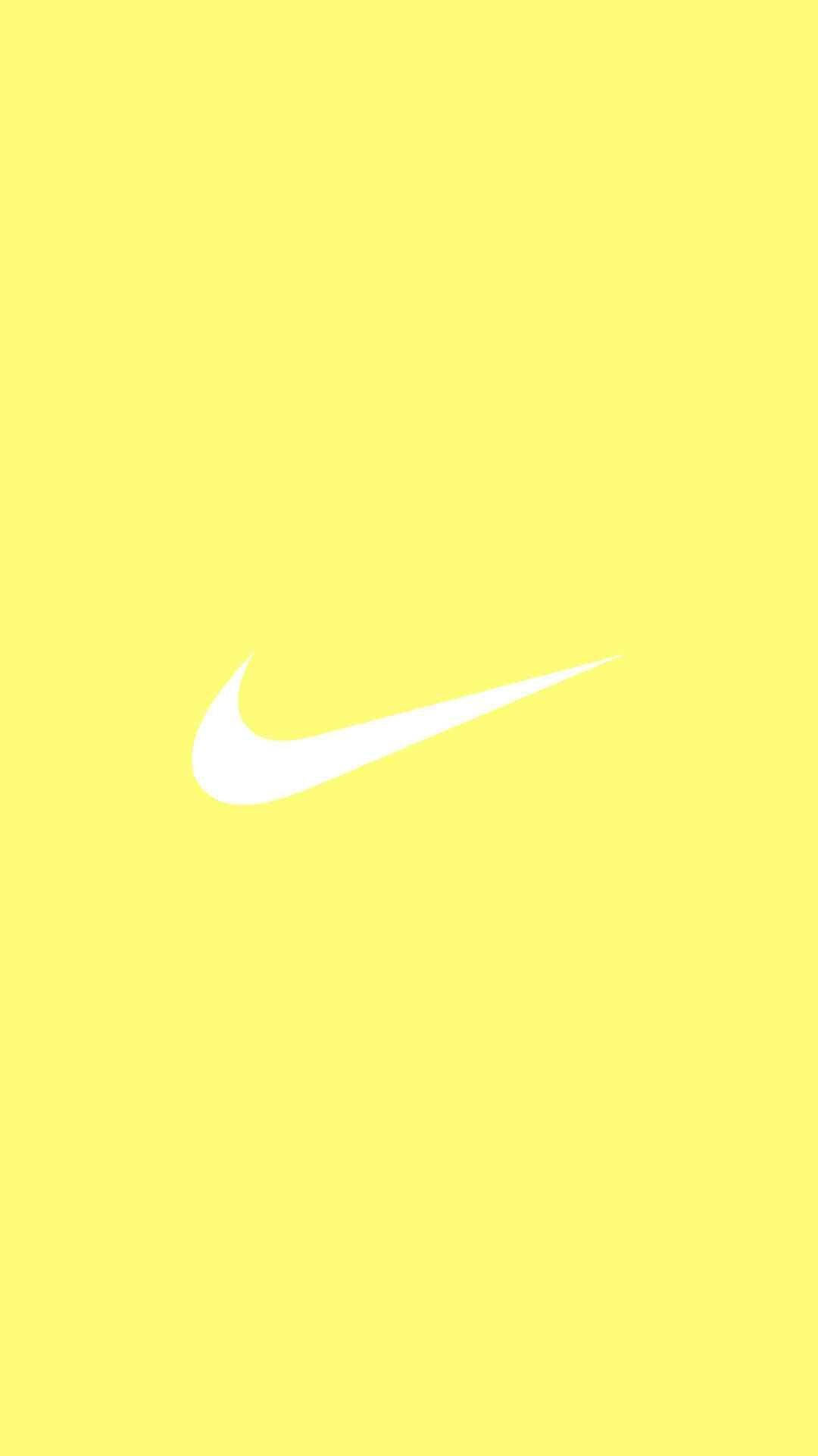Mesmerizing Splash of Cute Pastel Yellow Aesthetic with Iconic Nike Logo Wallpaper