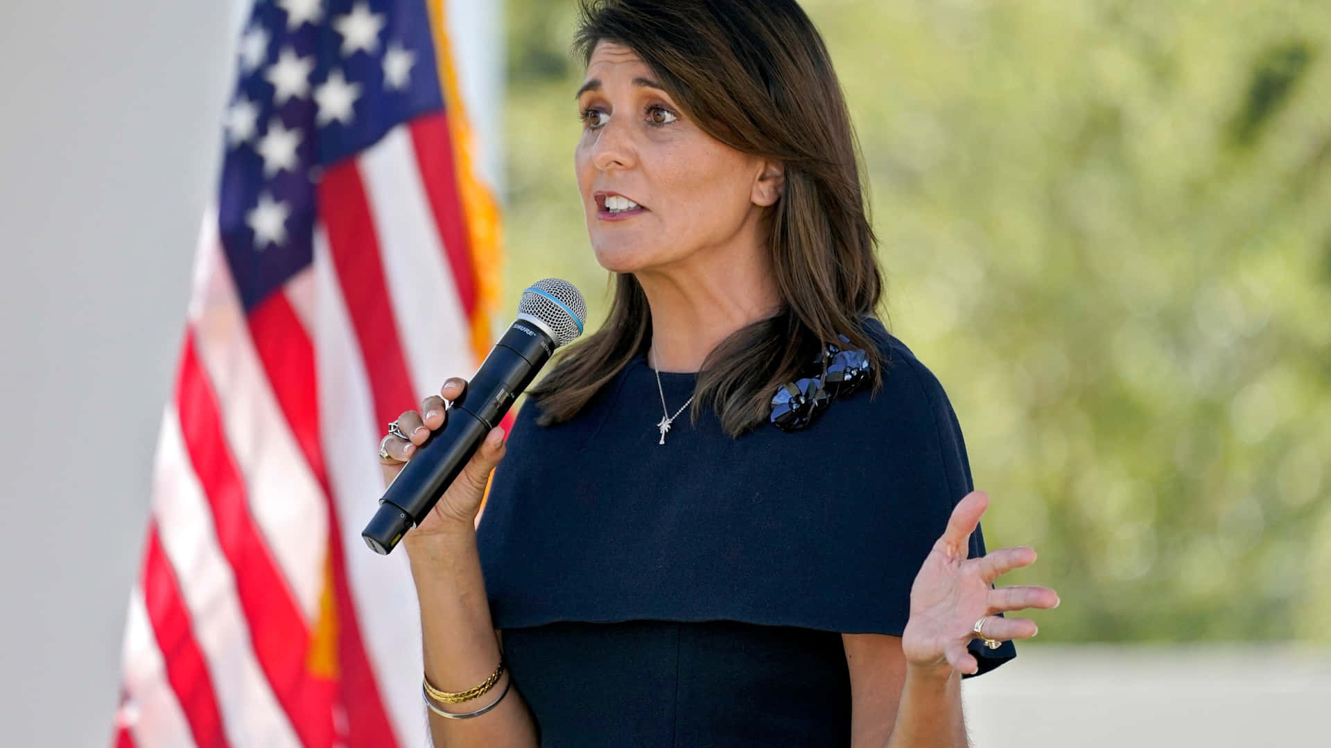 Nikki Haley delivering a speech holding a microphone Wallpaper