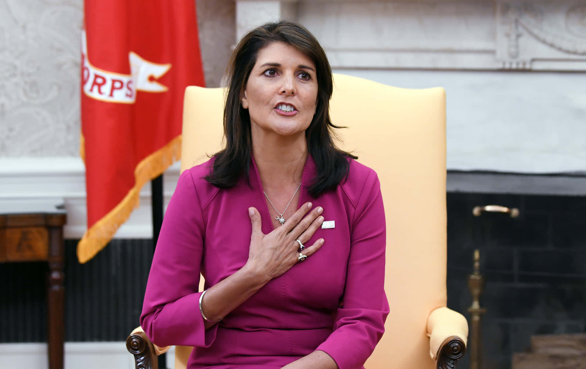 Nikki Haley With Her Hand On Her Chest Wallpaper