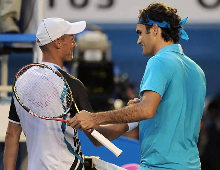 Caption: Pro Tennis Players Nikolay Davydenko and Roger Federer Discussing During Match Wallpaper