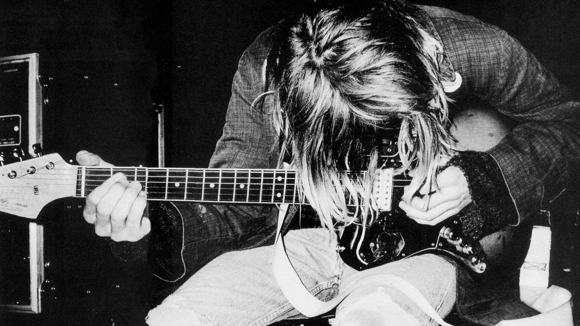 Nirvana Lead Vocalist Playing Guitar Wallpaper