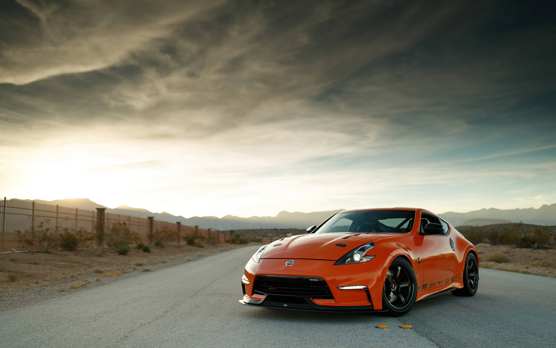 1.  A sporty Nissan 370Z on the road Wallpaper