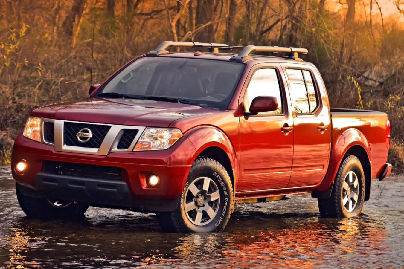 Nissan Frontier Powering Through Beautiful Scenery Wallpaper