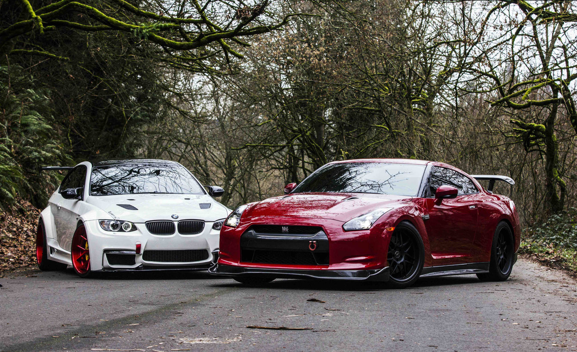 A captivating showdown between the Nissan Skyline GTR R35 and a stunning white BMW. Wallpaper