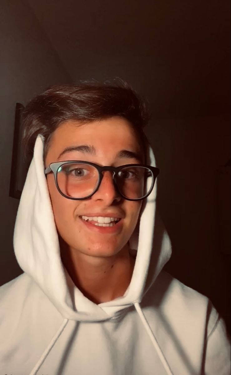 Noah Schnapp With Eyeglasses And White Hoodie Wallpaper