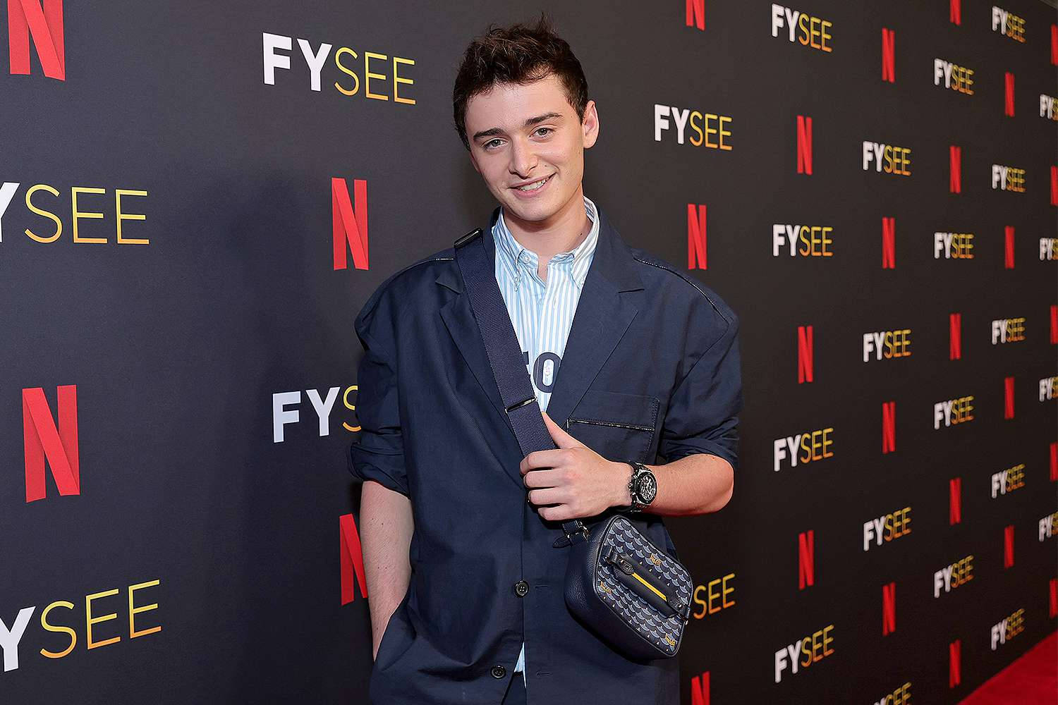 Noah Schnapp With Suit And Sling Bag Wallpaper