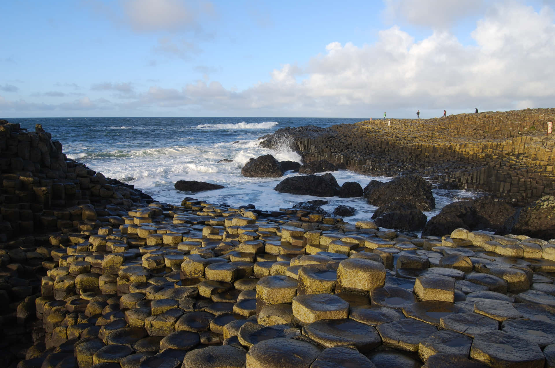 Majestic View of Giant’s Causeway Under a Moody Sky Wallpaper