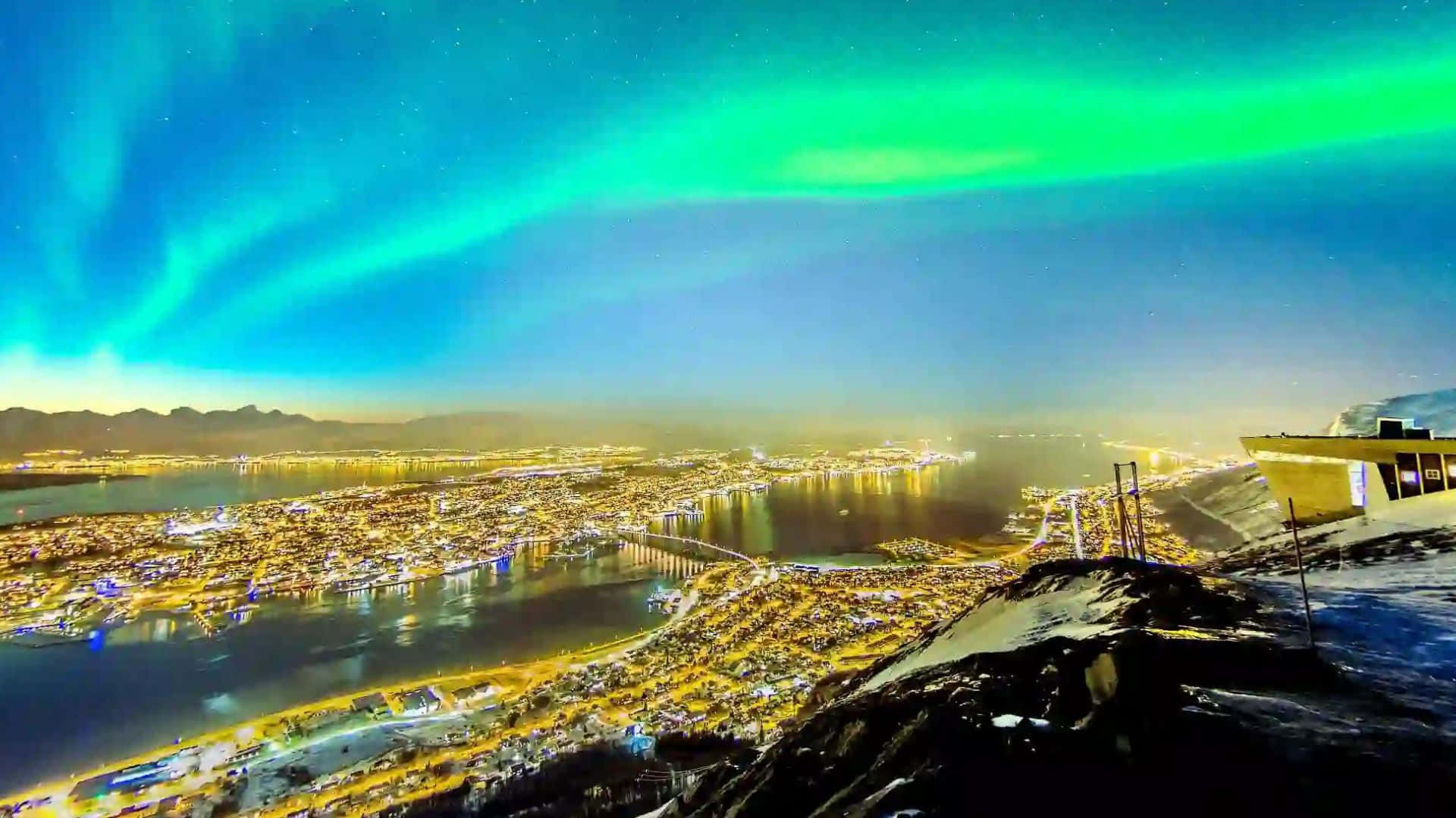 Northern Lights Dancing Over Tromsø City Wallpaper