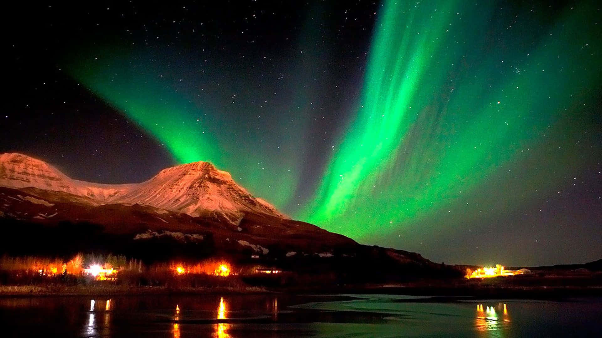 An ethereal sight of the Northern Lights above a breathtaking landscape.
