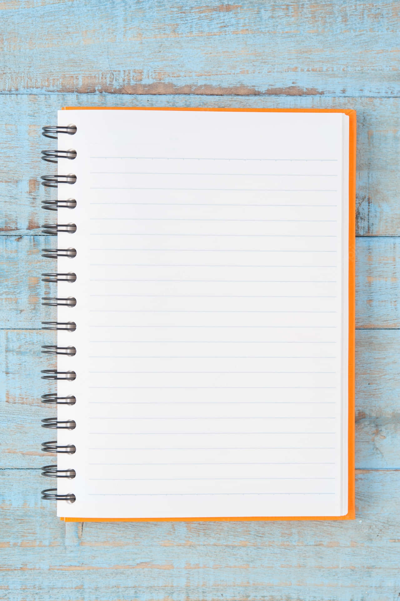 A Notebook On A Blue Wooden Background