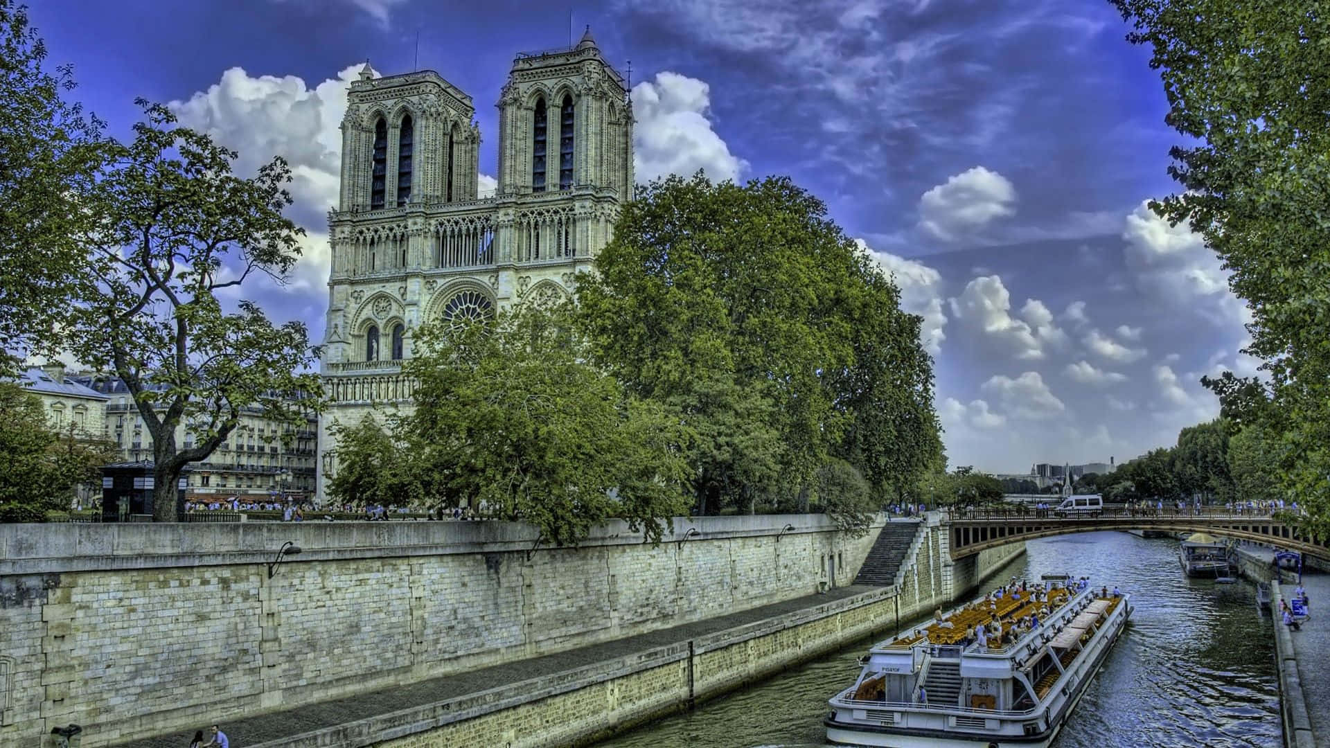 Notre Dame Cathedral With Boat Along The Seine Picture