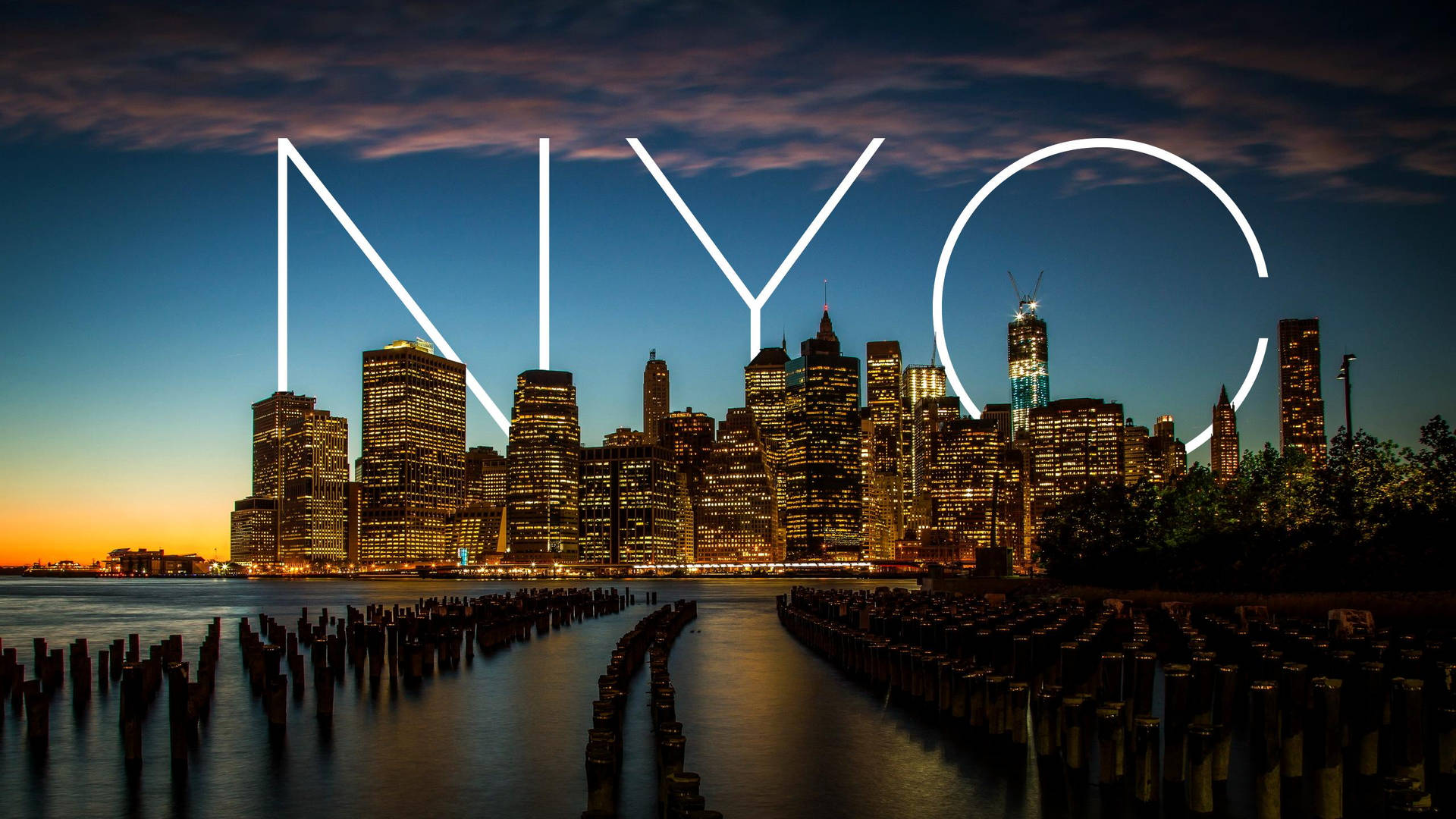 New York City Wallpaper — New York City skyline at twilight with glowing 'NYC' letters superimposed over water and wooden pilings.
