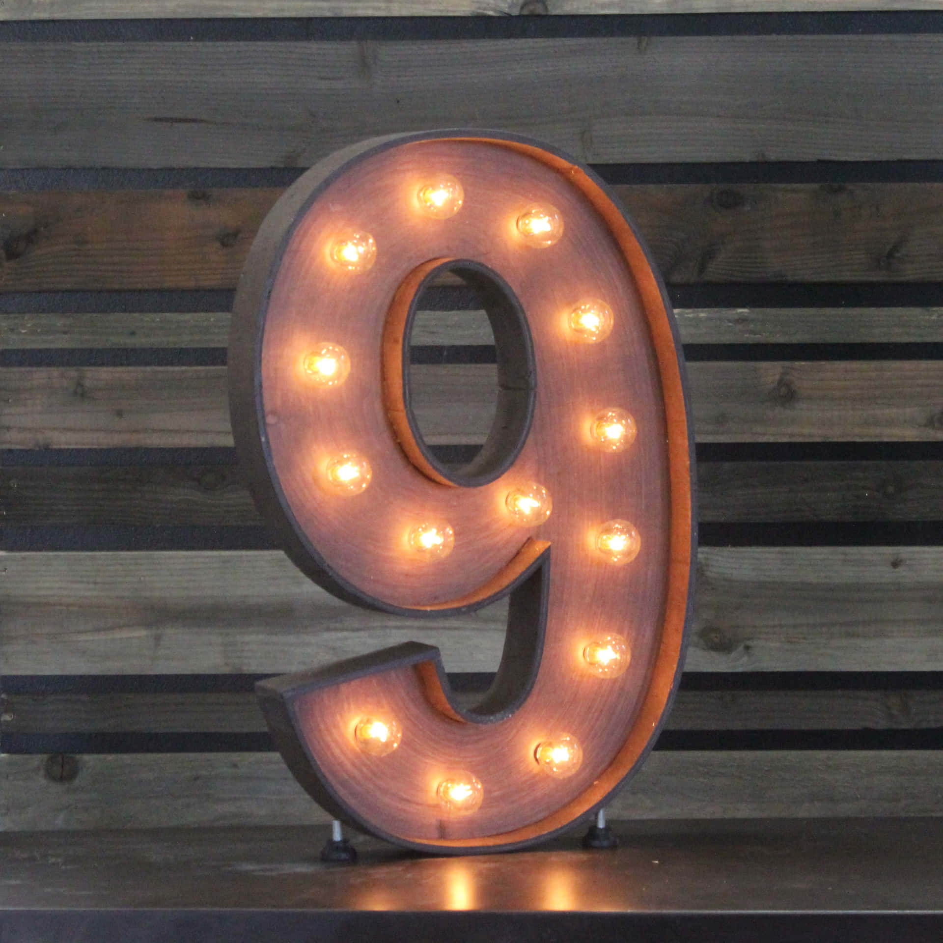 A Wooden Number With Lights On It Wallpaper