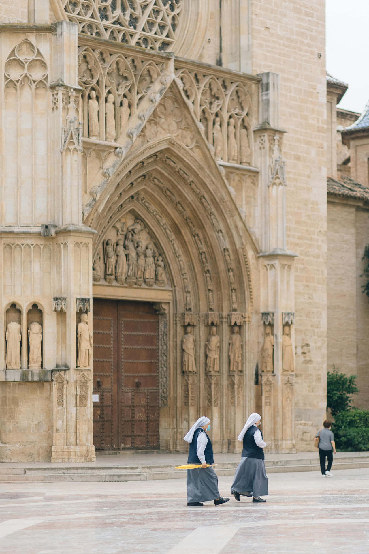 Nuns_ Walking_ By_ Gothic_ Church Wallpaper