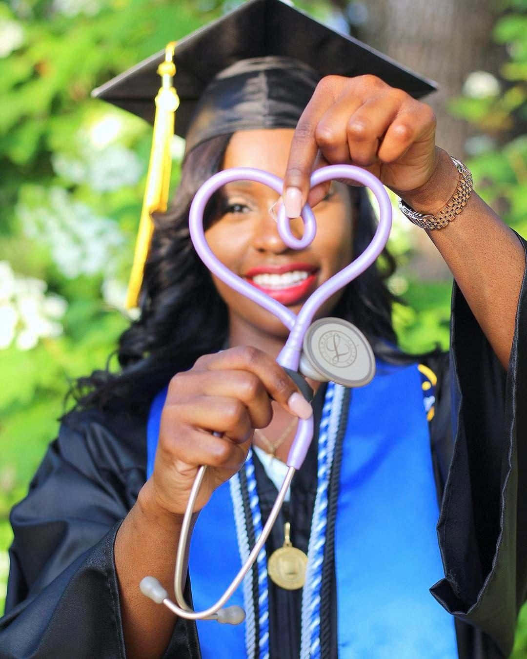 A Graduate Holding A Heart Shaped Stethoscope