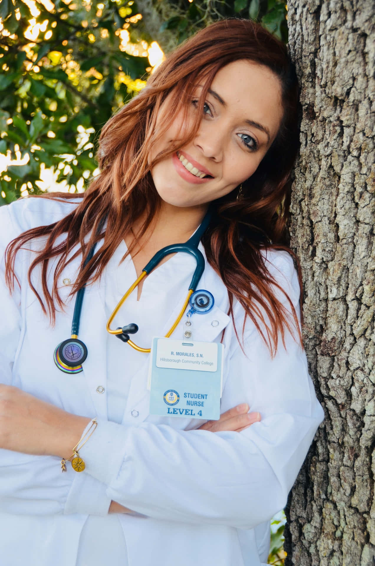 A Woman In A White Coat Leaning Against A Tree