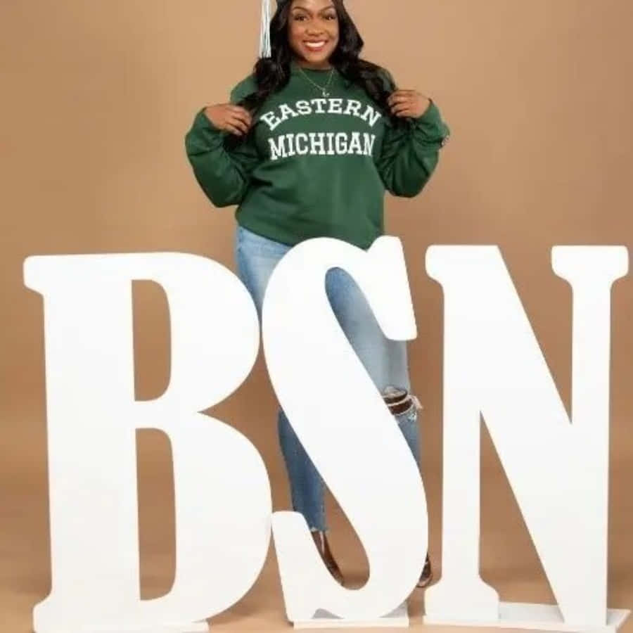 A Woman Standing Next To A Large Sign That Says Bsn