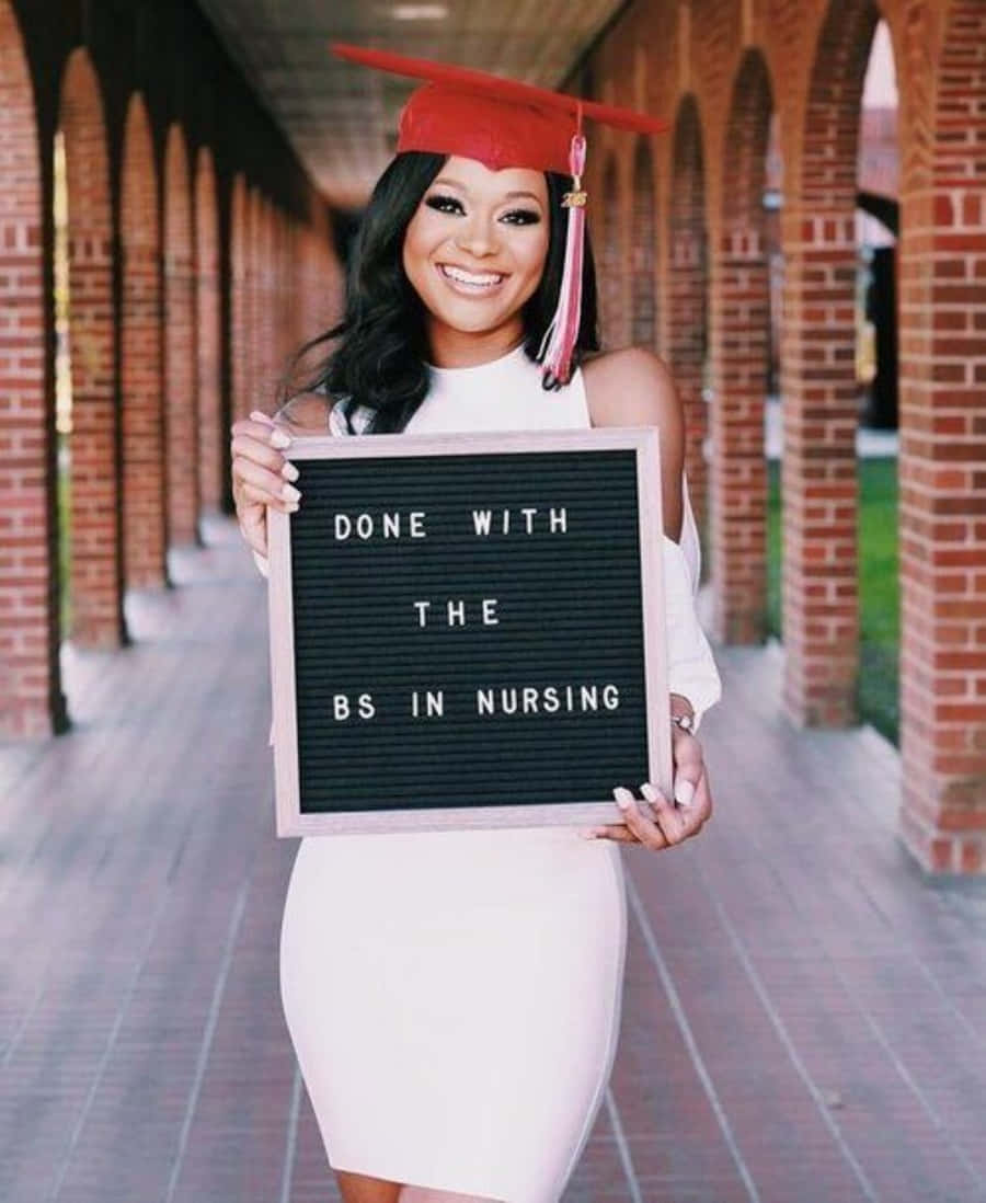 A Woman Holding A Sign That Says Done With The Be In Nursing