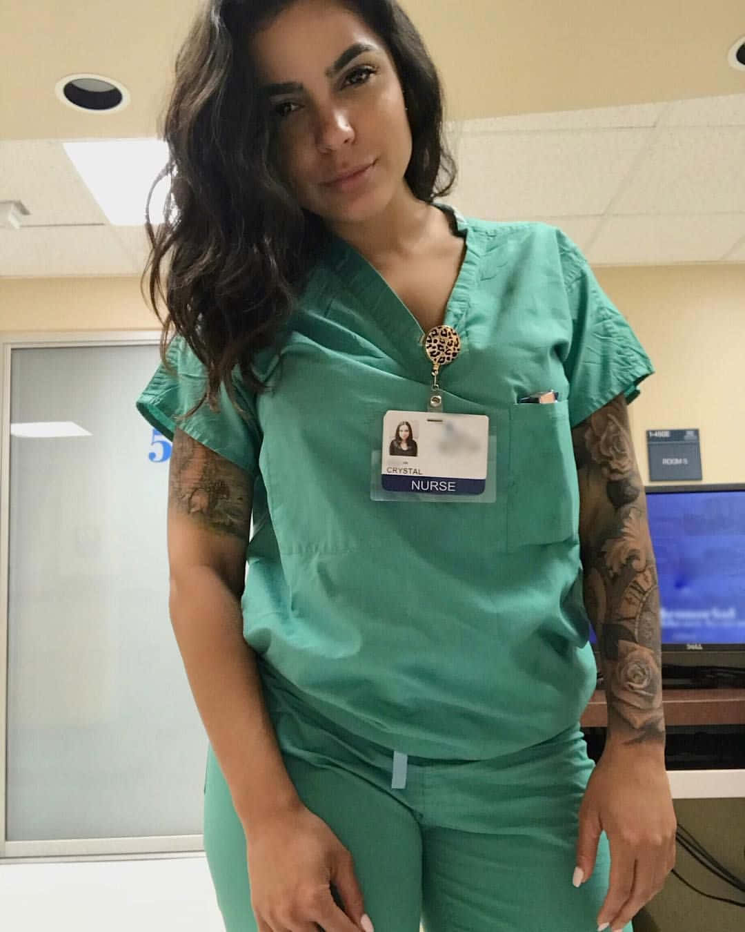 A Woman In Scrubs Posing For A Photo