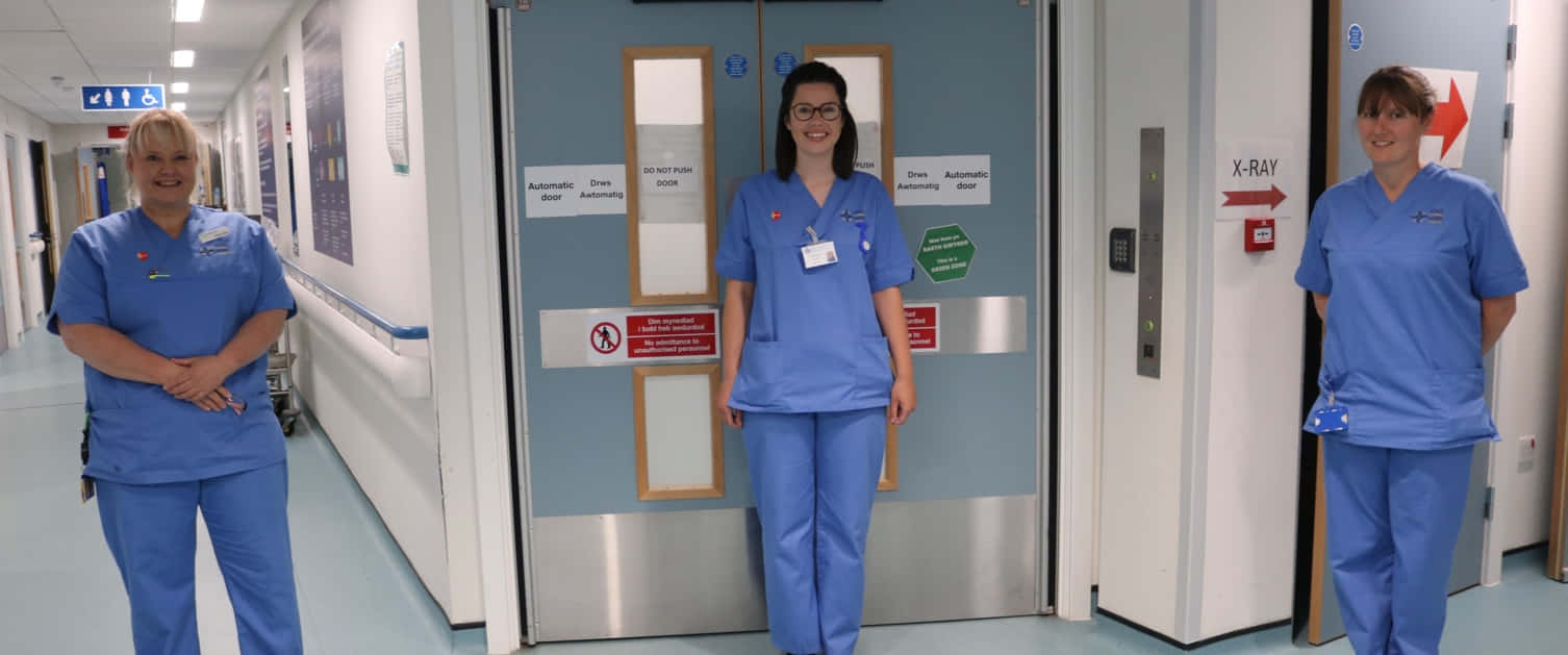 Four Nurses Standing In Front Of A Door