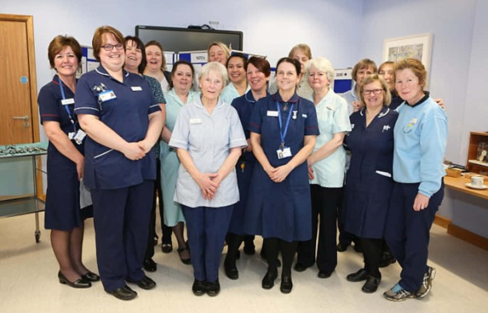 A Group Of Nurses Posing For A Photo In A Room