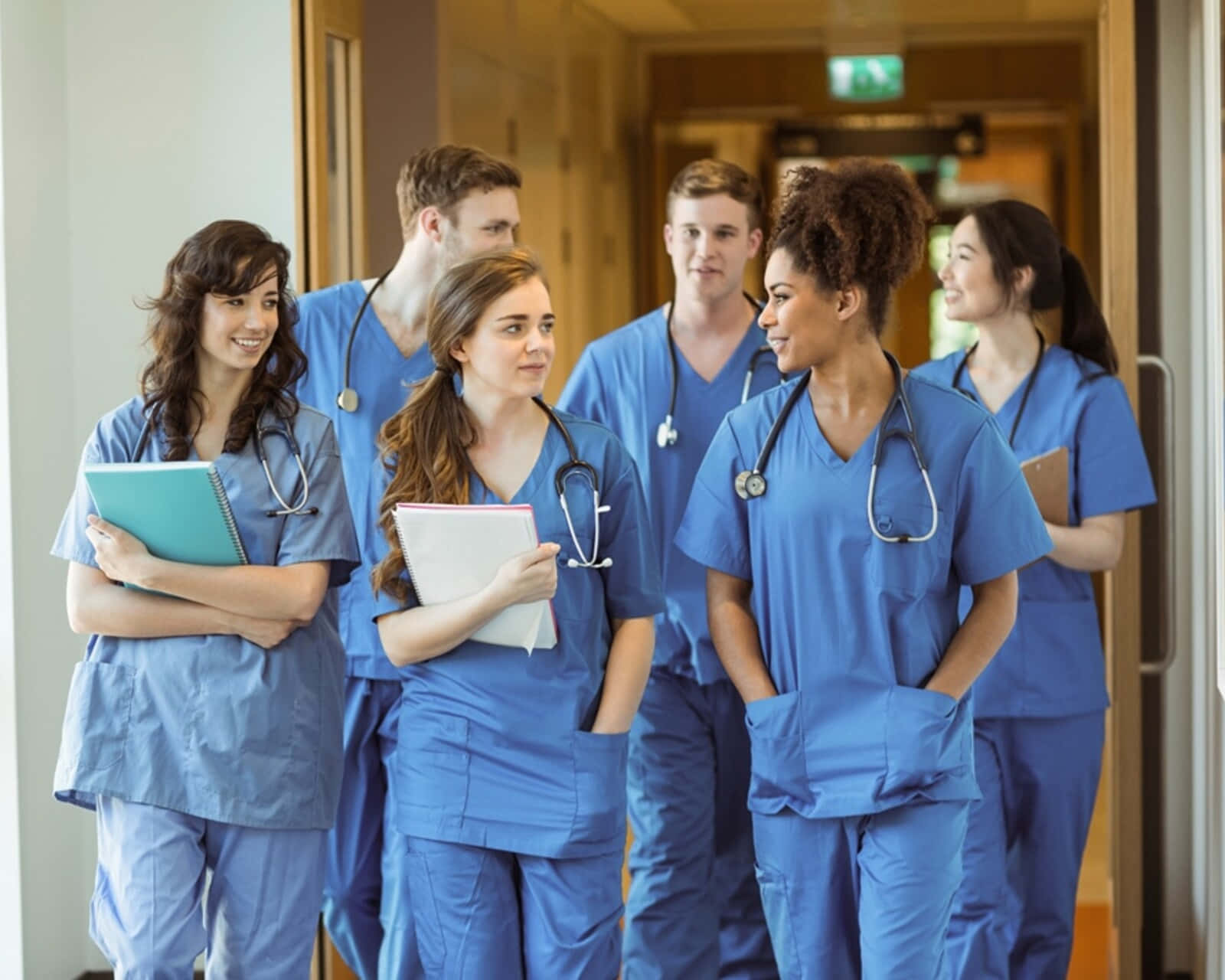 A Group Of Nurses Standing In A Hallway
