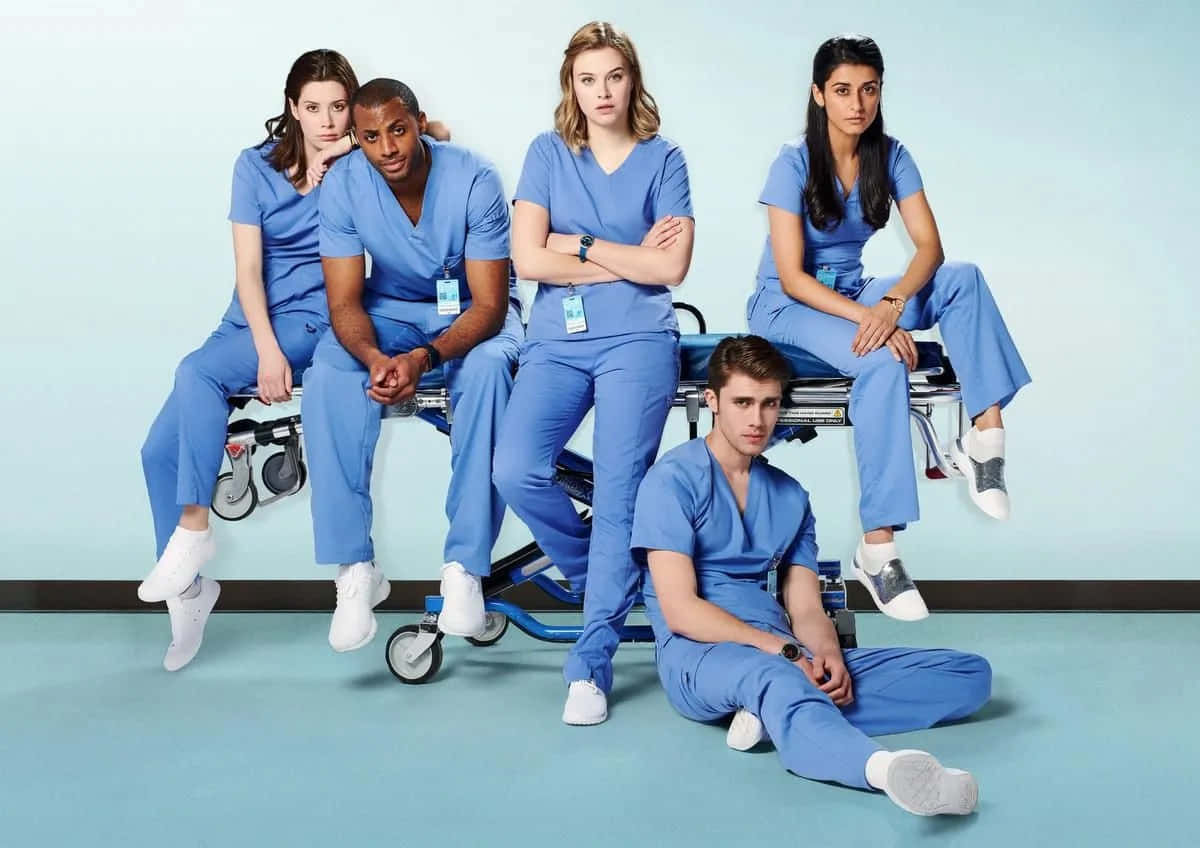 A Group Of People In Scrubs Posing For A Photo