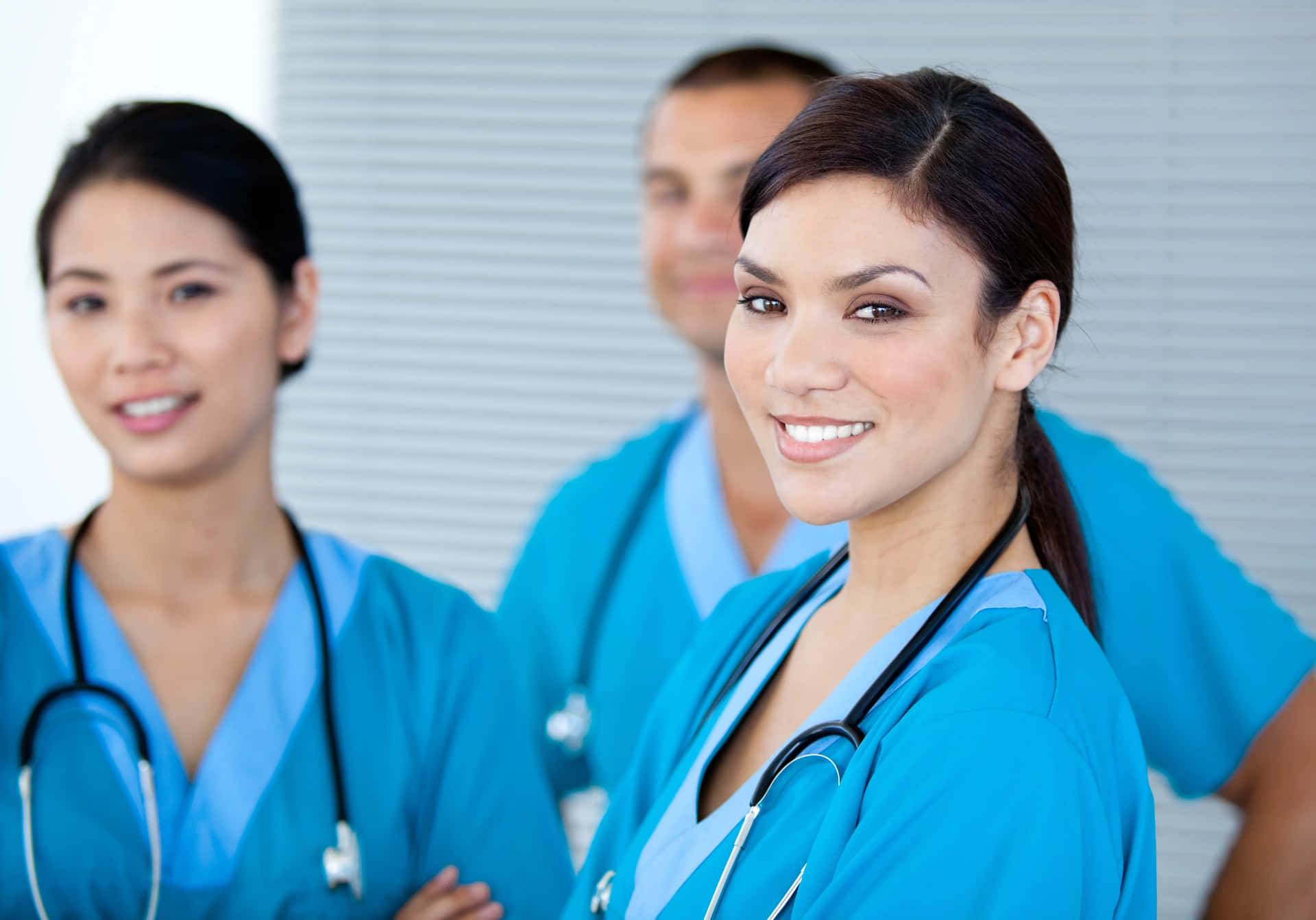 Three Nurses Standing Together In A Group
