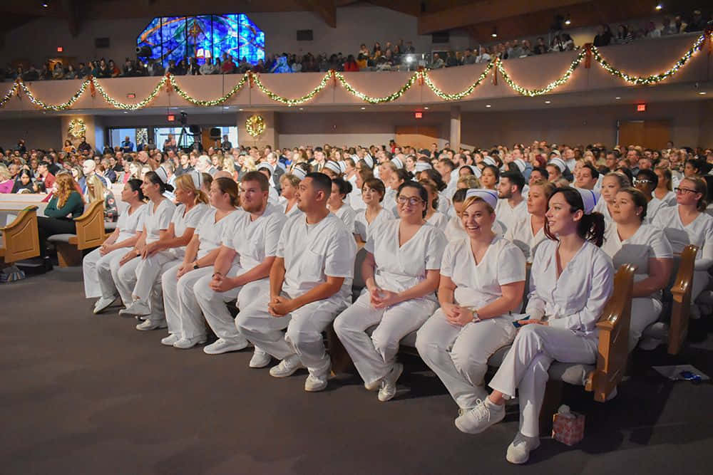 A Group Of Nurses Sitting In A Church
