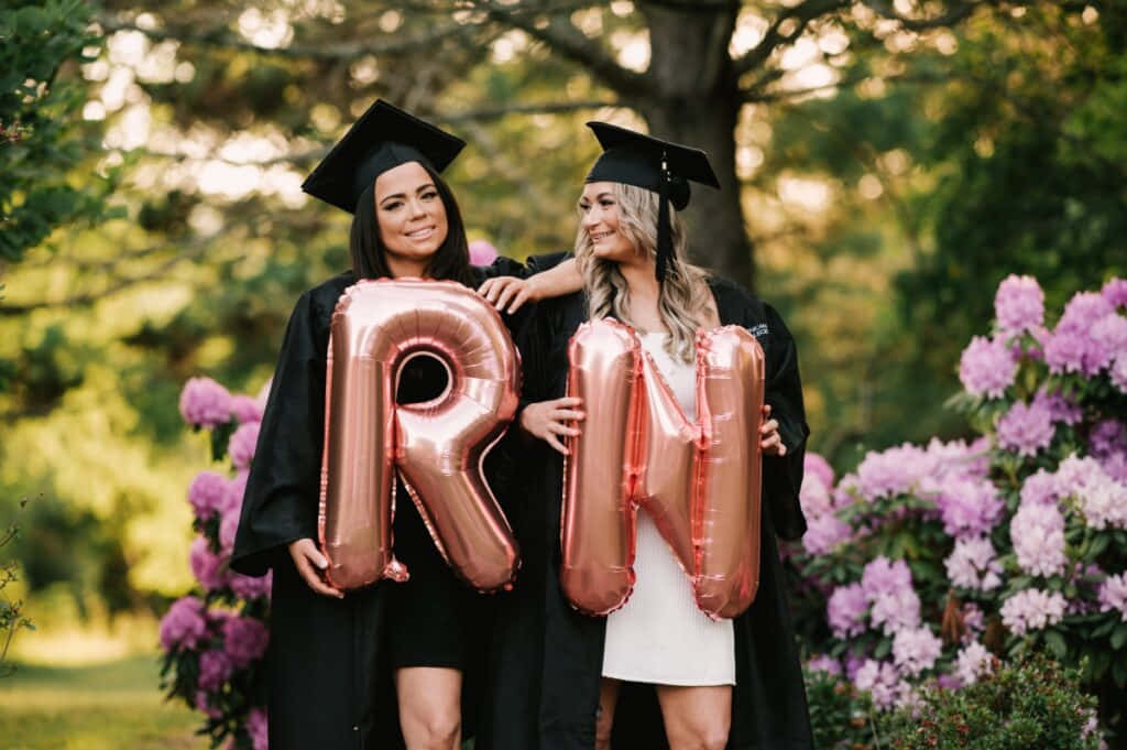 Two Women Holding Balloons With The Letter R