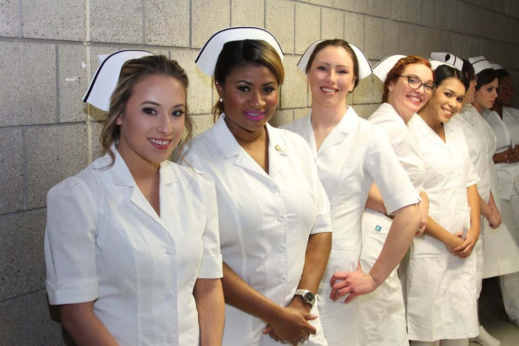 A Group Of Nurses Standing In A Hallway
