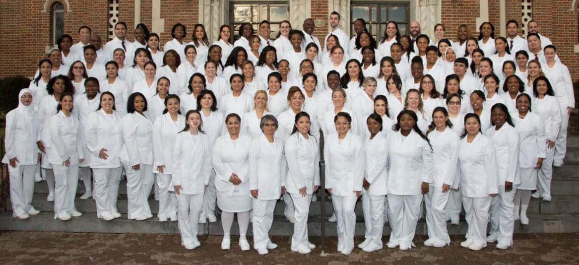 A Group Of People In White Lab Coats Posing For A Photo