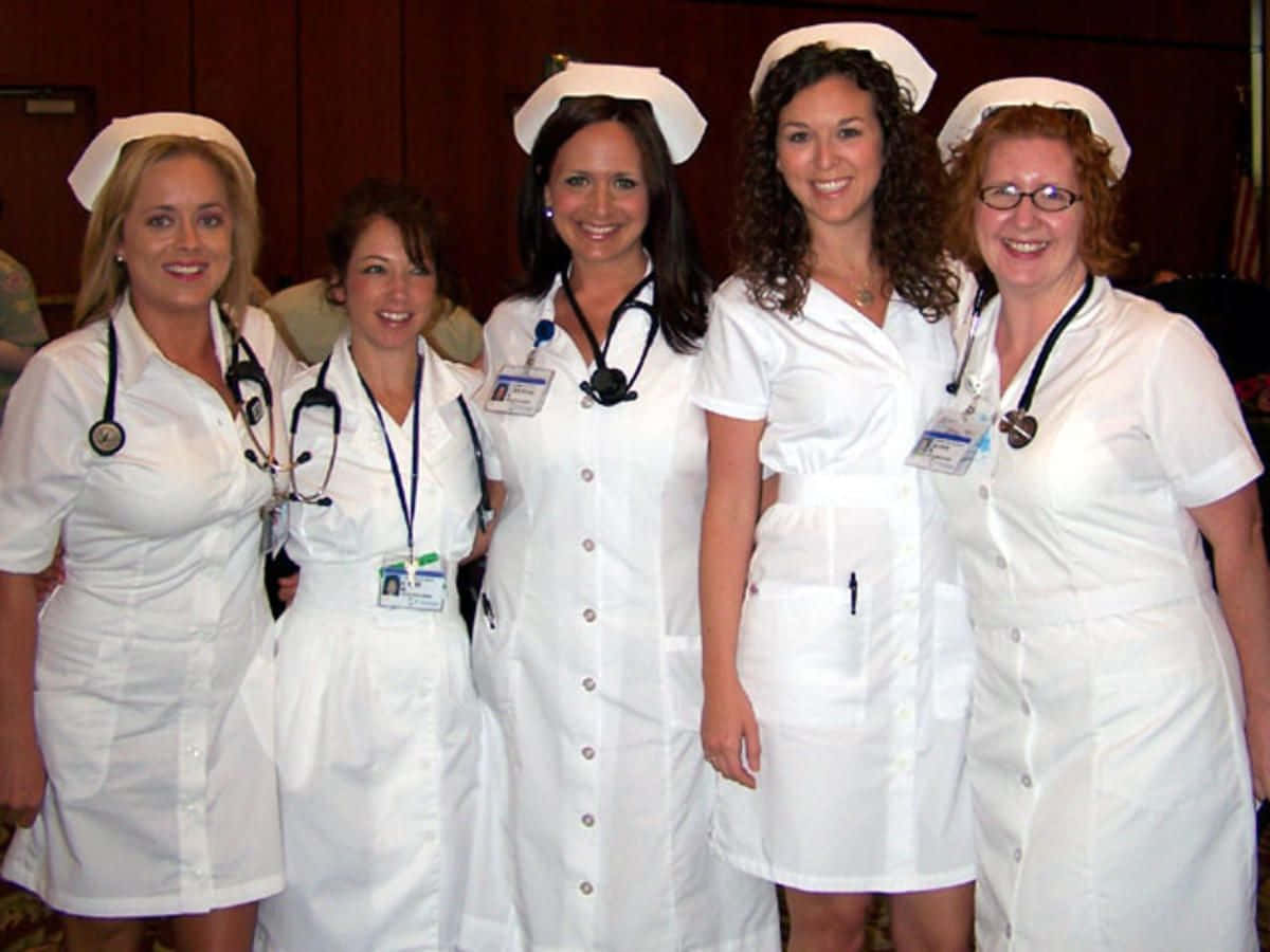 A Group Of Women In White Nurse Uniforms