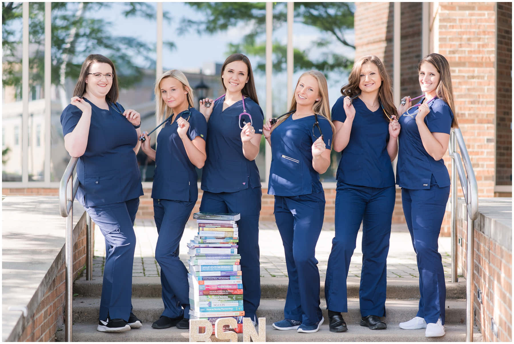 A Group Of Female Nurses Posing With Books